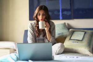 work from home stay at home mom drinking coffee and on computer