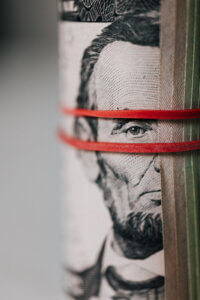 roll of american dollars tightened by rubberband