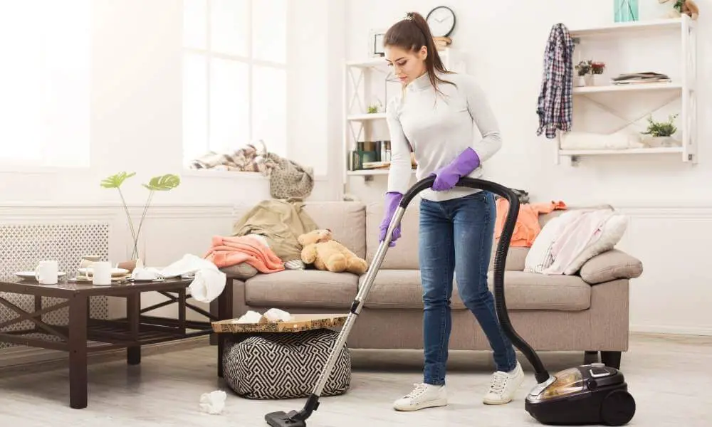 teen cleans house with vacuum