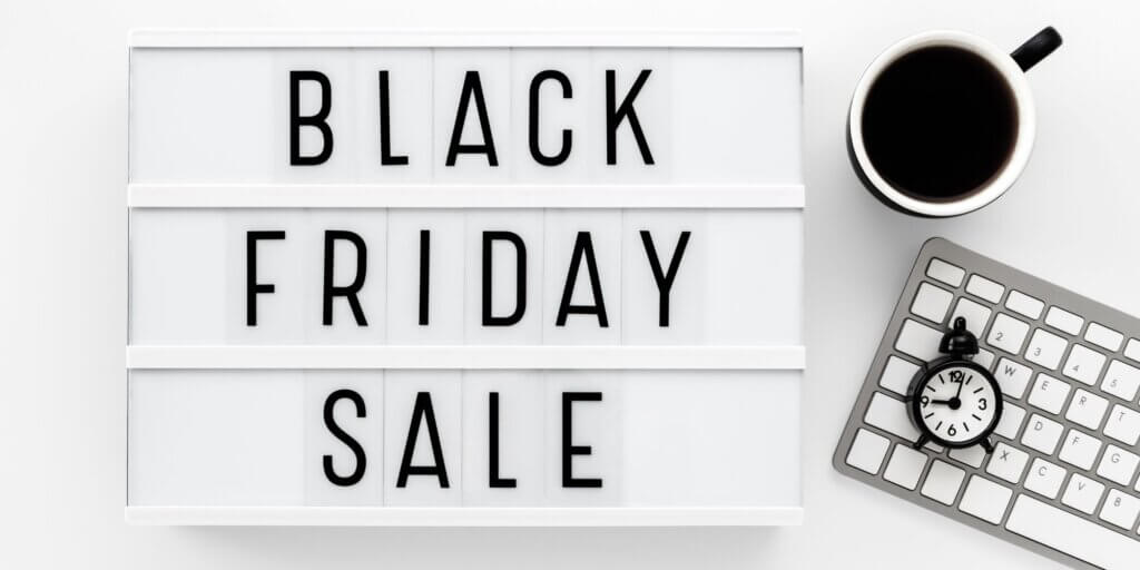 black friday sale sign, black coffee, clock and keyboard