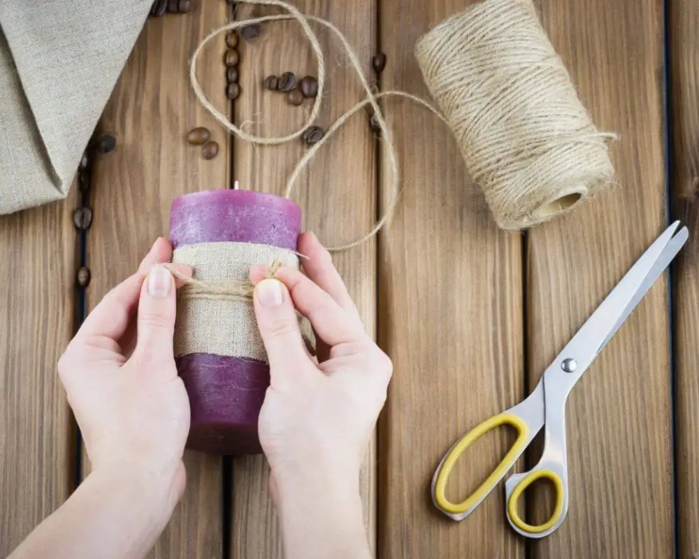 hands making wrap around a candle